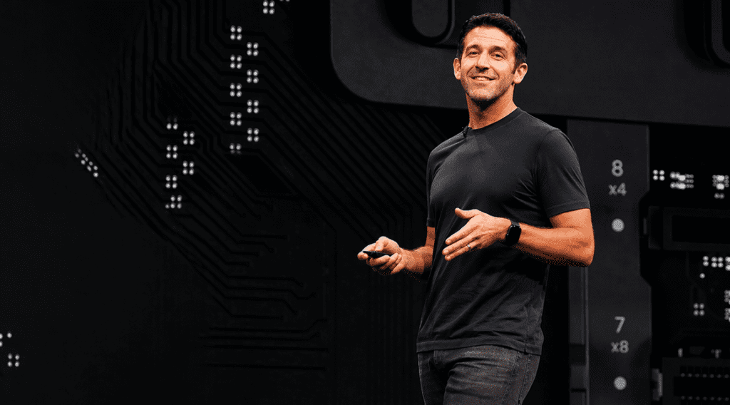John Ternus speaking at Apple event as new CEO, wearing black t-shirt on stage